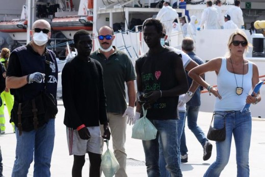 Rescued migrants disembark from the Italian Navy frigate 'Dattilo after it arrives at the harbor of Palermo following a rescue operation for 717 migrants who they were traveling aboard dinghies 7 off Sicily Channel, Palermo, 11 July 2015. ANSA/ MIKE PALAZZOTTO